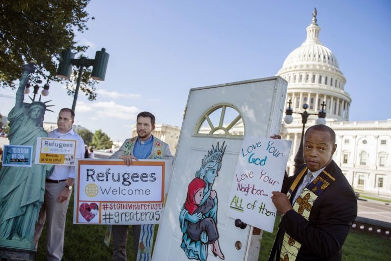 Religious leaders and activists from Church World Service hold up a door, closed to refugees, during a protest urging congress to pressure US President Donald Trump to allow more refugees to enter in front of the Capitol in September.