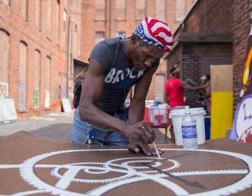 William Clack, who lives near the abandoned warehouse in Kensington, contributed many panels to the installation.  (Lindsay Lazarski/WHYY)