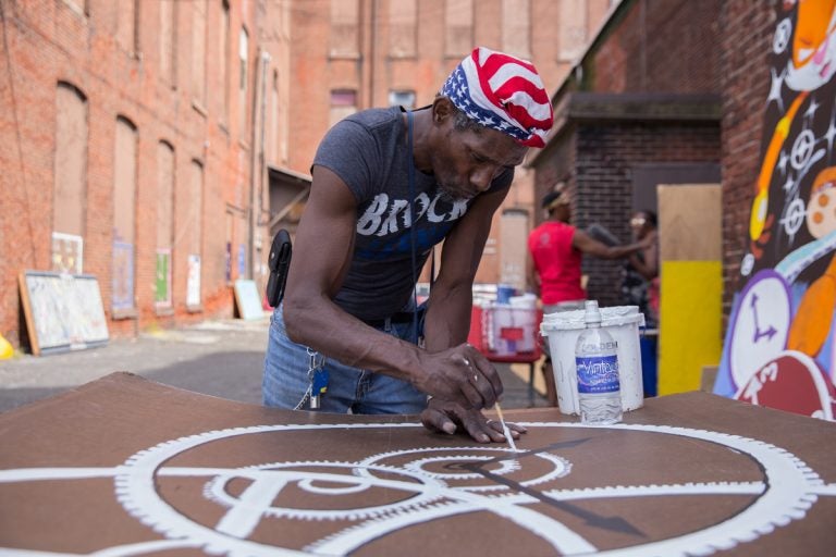 William Clack, who lives near the abandoned warehouse in Kensington, contributed many panels to the installation.  (Lindsay Lazarski/WHYY)