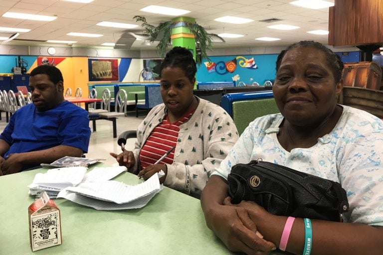 José, Nelly and Gloria Guity in the cafeteria of Miami Edison Senior High School the day before Irma hit Miami. (Kate Stein/WHYY)