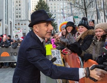 Matt Lauer greets people in a crowd outside of NBC studios in New York City.