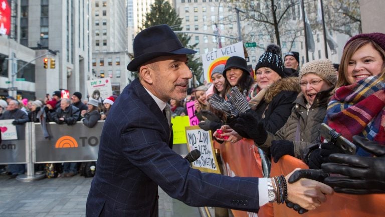 Matt Lauer greets people in a crowd outside of NBC studios in New York City.