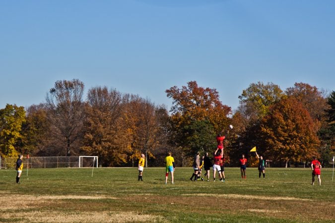 Players on the Rogue Samurai Men lift a man during a line-out. (Kimberly Paynter/WHYY)