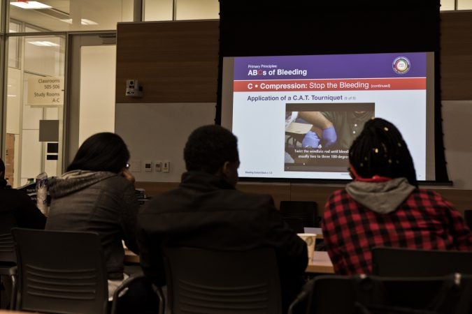 Students from the Sayre, West Philadelphia, and The U School learn about wound care at a Stop The Bleed training. (Kimberly Paynter/WHYY)