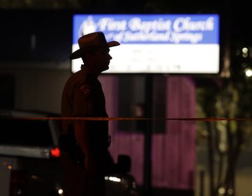 A law enforcement official stands watch outside the First Baptist Church of Sutherland Springs, the scene of a mass shooting, Sunday, Nov. 5, 2017, in Sutherland Springs, Texas. A man dressed in black tactical-style gear and armed with an assault rifle opened fire inside the church in the small South Texas community on Sunday, killing and wounding many. The dead ranged in age from 5 to 72 years old. (AP Photo/Eric Gay)