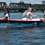 Children row in a Philadelphia Waterborne boat on the Schuylkill River