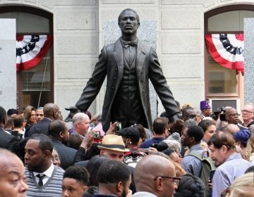 An eager crowd surrounds the statue of Octavius Catto after its unveilling on the Southwest apron of City Hall. (Emma Lee/WHYY)