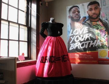 The SILENCE=DEATH gown worn by activist Dominic Bash stands beside a 2017 poster in the William Way exhibit documenting Philadelphia's battle against AIDS