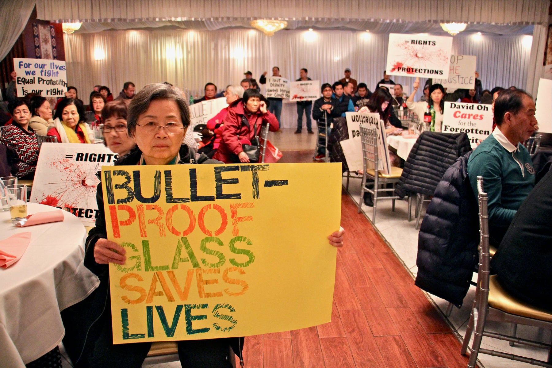 Mary Heng, whose daughter owns a stop-and-go in North Philadelphia, attends a press conference at Saigon Maxim restaurant to speak out against a bill that could force owners to remove the bullet-proof glass from their businesses. Stop -and-gos operate under restaurant licenses, selling beer and liquor for consumption on premises. 