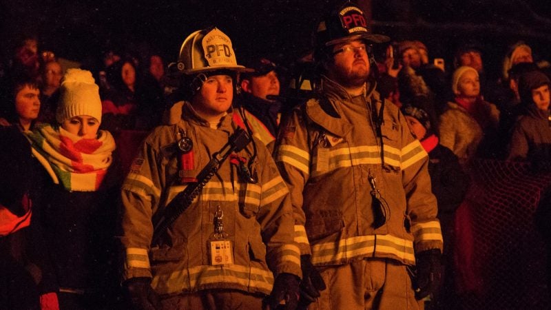 Firefighters keep a close eye on the phoenix as it burns at the 14th Annual Firebird Festival in Phoenixville. (Emily Cohen for WHYY)