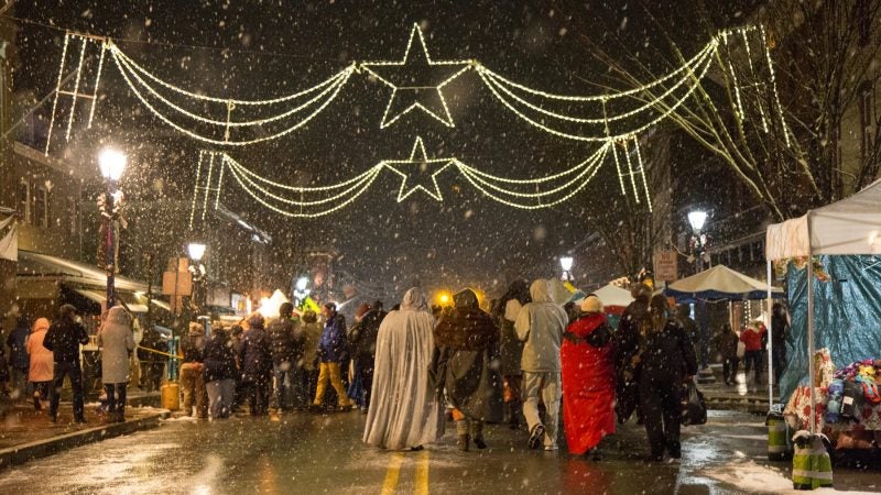 Revelers visit the street festival of the very snowy 14th Annual Firebird Festival in Phoenixville, Pennsylvania. (Emily Cohen for WHYY)