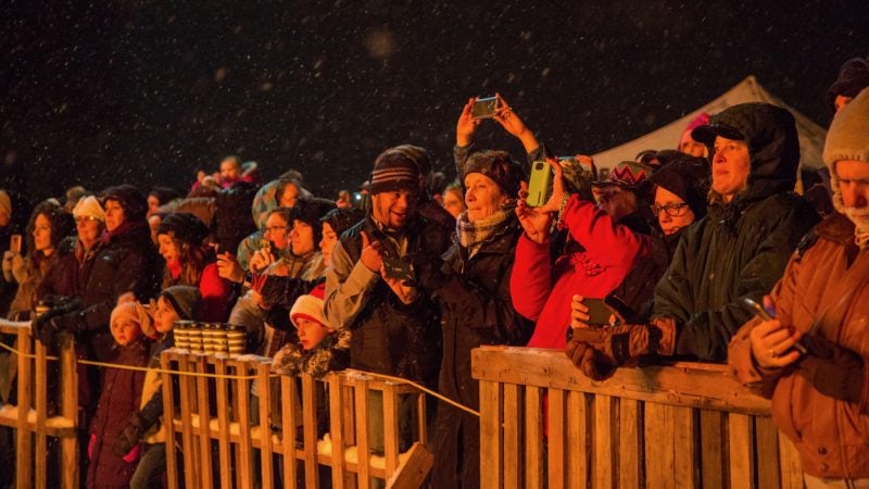 The crowds watch in awe as they watch the phoenix catch fire at the 14th Annual Firebird Festival in Phoenixville, PA December 9th 2017. (Emily Cohen for WHYY)