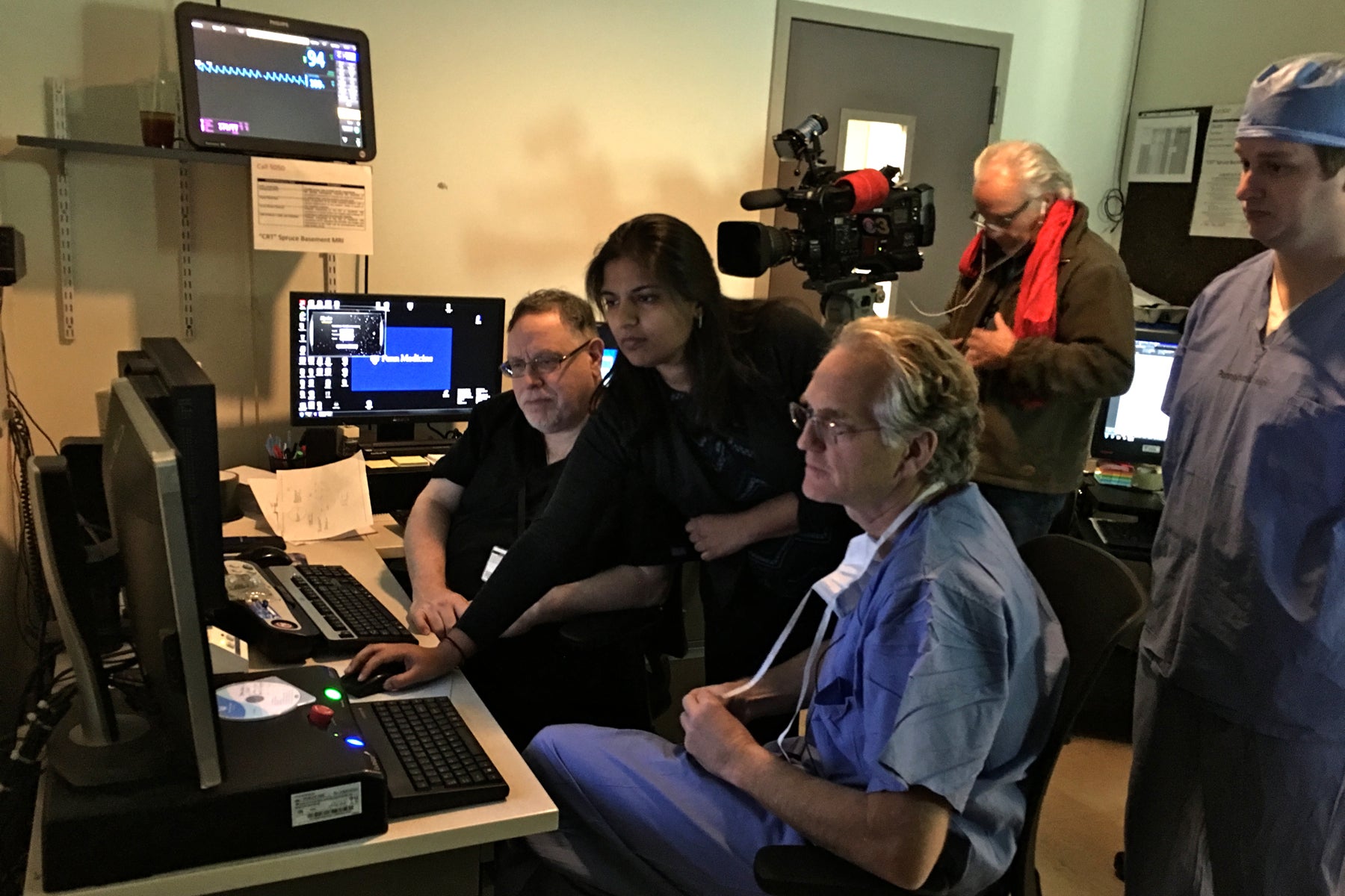 Dr. Gordon Baltuch oversees MRI and CT scans as he preps for an MRI-guided targeted ultrasound procedure. 