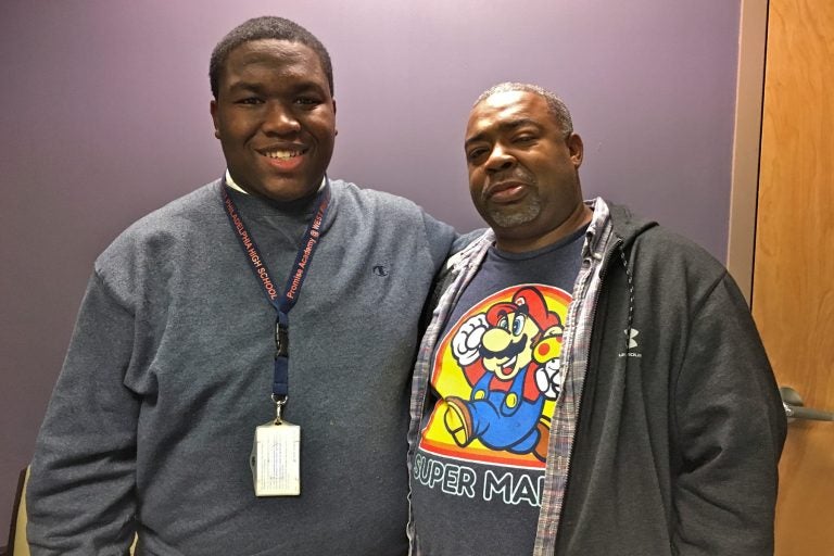 Ahmad Harrington (left) stands beside his father, James.