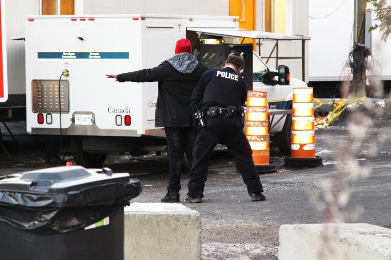 A man from Congo is frisked by Royal Canadian Mounted Police officers after illegally entering Canada, near the border with Champlain, N.Y. (Lorne Matalon)