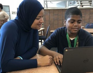 Teacher Syreeta Thomas works with Kahleel Odom during Ethel Allen Elementary School's hour of coding.