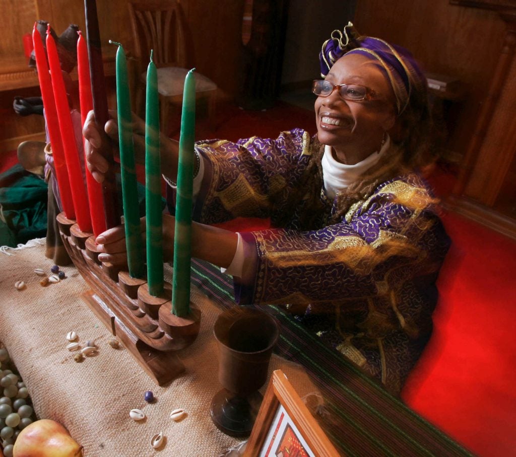 This photo taken Dec. 8, 2009 shows Ruth Ndiagne Dorsey with a Kwanzaa setting set up for a media photo at her church, The Shrine of the Black Madonna, in Atlanta.