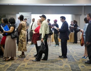 People wait in line to meet with recruiters during a job fair in Philadelphia