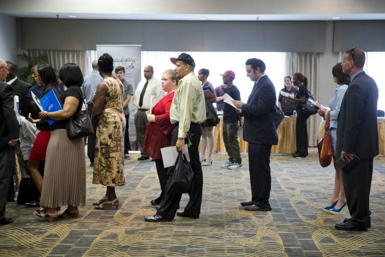 People wait in line to meet with recruiters during a job fair in Philadelphia