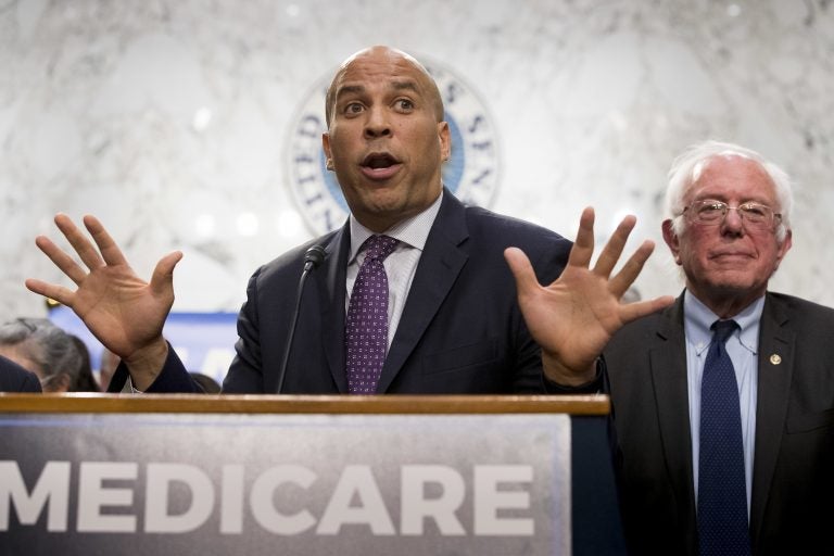 Sen. Cory Booker and Sen. Bernie Sanders speak during a news conference on Capitol Hill in Washington to unveil their Medicare for All legislation to reform health care.