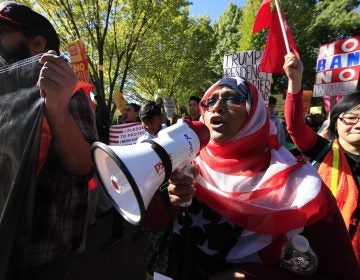 Bangladeshi descent American Hoshneara Begum, center, leads chant of slogans against what they call a 