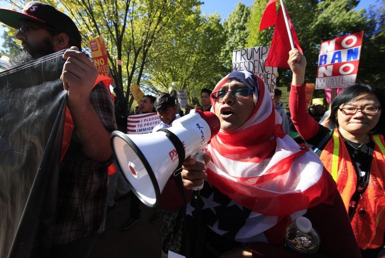 Bangladeshi descent American Hoshneara Begum, center, leads chant of slogans against what they call a 