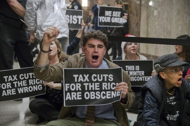 Protesters shout their disapproval of the Republican tax bill outside the Senate Budget Committee hearing room on Capitol Hill in Washington, Tuesday, Nov. 28, 2017.