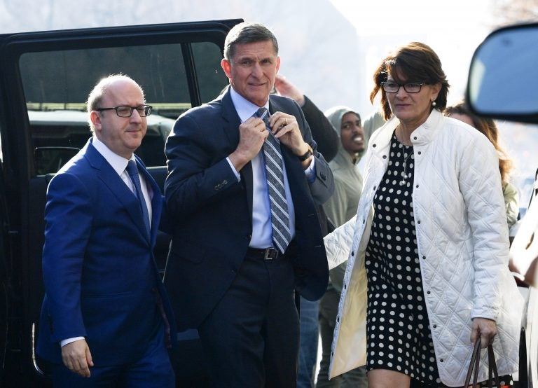 Former Trump national security adviser Michael Flynn, center, arrives at federal court in Washington, Friday, Dec. 1, 2017. Court documents show Flynn, an early and vocal supporter on the campaign trail of President Donald Trump whose business dealings and foreign interactions made him a central focus of Mueller's investigation, will admit to lying about his conversations with Russia's ambassador to the United States during the transition period before Trump's inauguration.