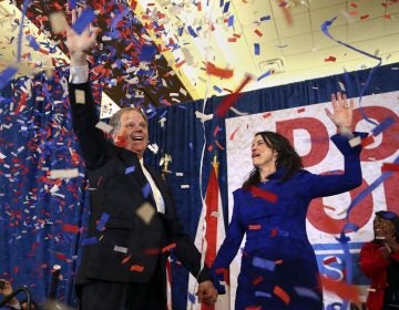 Democratic candidate for U.S. Senate Doug Jones and his wife Louise wave to supporters before speaking Tuesday, Dec. 12, 2017, in Birmingham, Ala. Jones has defeated Republican Roy Moore, a one-time GOP pariah who was embraced by the Republican Party and the president even after facing allegations of sexual impropriety.