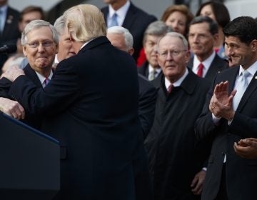 Speaker of the House Paul Ryan, R-WIs., right, applauds as President Donald Trump hugs Senate Majority Leader Mitch McConnell, R-Ky., as he speaks during an event on the South Lawn of the White House in Washington, Wednesday, Dec. 20, 2017, to acknowledge the final passage of tax overhaul legislation by Congress.