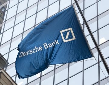 A flag for Deutsche Bank flies outside the German bank's New York offices on Wall Street, Friday, Oct. 7, 2016.