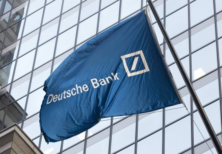 A flag for Deutsche Bank flies outside the German bank's New York offices on Wall Street, Friday, Oct. 7, 2016.