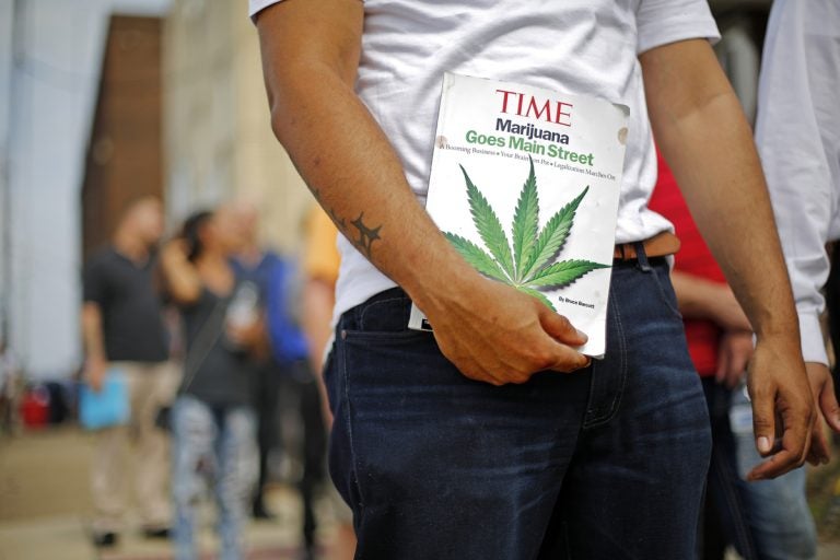 Michael Cole of Clairton, Pa., holds a Time magazine while waiting in line in downtown McKeesport, Pa., to attend a Medical Marijuana Job Fair, Thursday, July 27, 2017. (Gene J. Puskar/AP Photo)