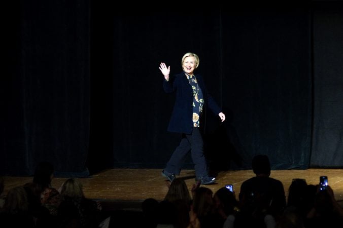 Hillary Clinton greets the crowd as she appears on stage during a book tour stop at the Academy of Music, on Thursday in Philadelphia. (Bastiaan Slabbers for WHYY)