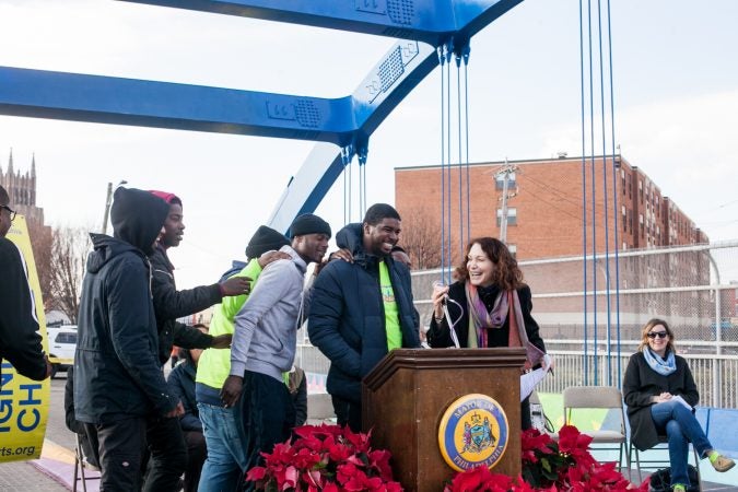 Jane Golden introduced members of the Youth Violence Reduction Parternship Guild who worked on the new mural recently completed on the B Street Bridge in Kensington. (Brad Larrison for WHYY)