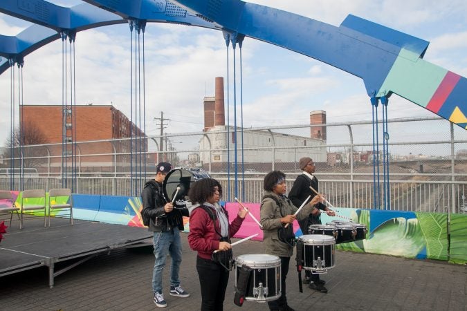 Kensington High School for the Creative and Performing Arts students Ebany Centeno, Marvelis Lima, Laquan Drago and Michael Colon performed on the B Street Bridge in Kensington before the dedication ceremony for a recently completed mural on the bridge. (Brad Larrison for WHYY)