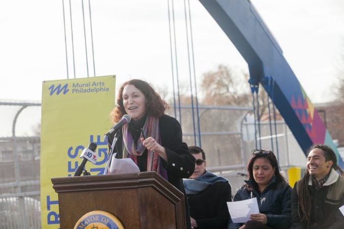 Jane Golden,Executive Director of Mural Arts, opened the dedication ceremony for a new mural that was recently completed on the B Street Bridge in Kensington Tuesday. (Brad Larrison for WHYY)