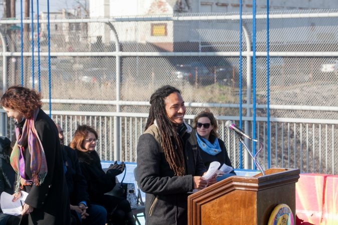 Lead artist Calo Rosa spoke at the dedication ceremony for the recently completed mural on the B Street Bridge in Kensington. (Brad Larrison for WHYY)