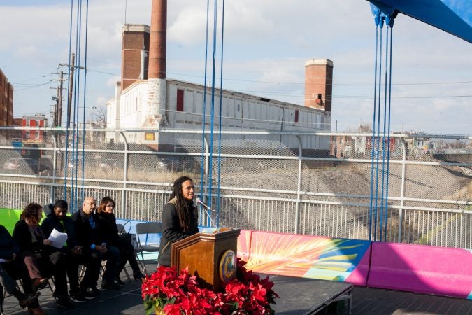 Lead artist Calo Rosa spoke at the dedication ceremony for the recently completed mural on the B Street Bridge in Kensington. (Brad Larrison for WHYY)
