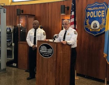 First Deputy Commissioner Myron Patterson, at podium, and Capt. Sekou Kinebrew, a police spokesman, talk to reporters Thursday at Philadelphia police headquarters about a deadly police-involved shooting in Ogontz. (Dana DiFilippo/WHYY)