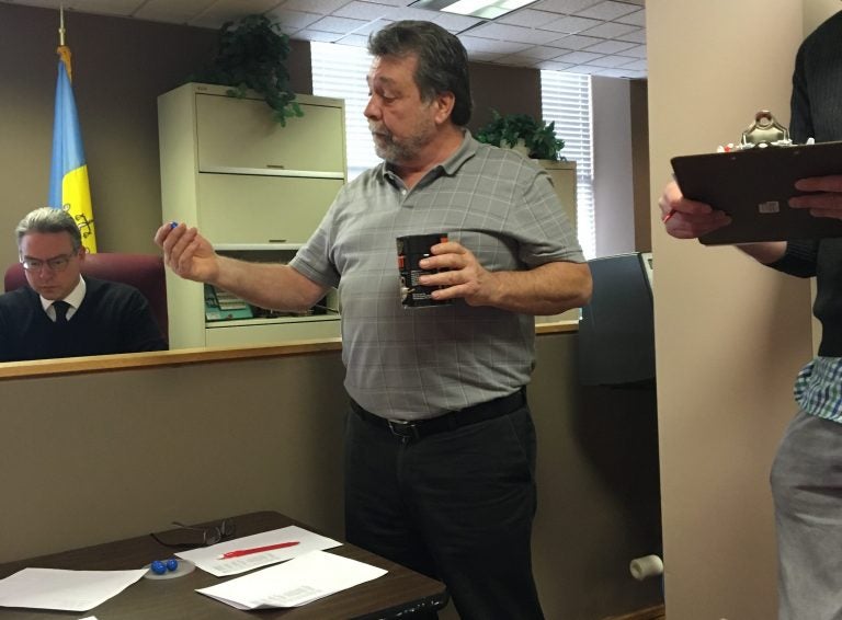 Philadelphia Acting Supervisor of Elections Kevin Kelly breaks a tie in an election board race by drawing numbered tokens from a coffee can.