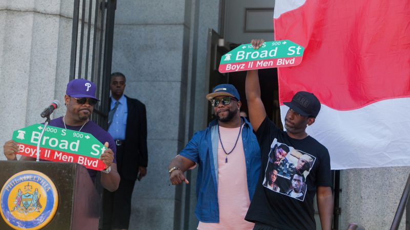 Boyz II Men with their newly unveiled Boyz II Men Boulevard signs stand in front of their alma mater the Philadelphia High School for Creative and Performing Arts. (Brad Larrison for NewsWorks) II Men