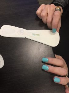 Edwards demonstrates the Lia pregnancy test- One end has ridges that encourage liquid to bead, while the other has a quilted pattern to absorb a sample.