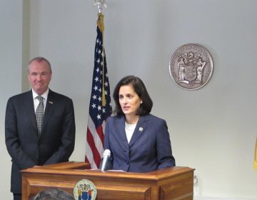 Assemblywoman Liz Muoio, standing with Gov.-elect Phil Murphy,  says she's looking forward to being confirmed as New Jersey state treasurer. (Phil Gregory/WHYY)