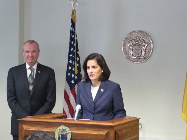 Assemblywoman Liz Muoio, standing with Gov.-elect Phil Murphy,  says she's looking forward to being confirmed as New Jersey state treasurer. (Phil Gregory/WHYY)