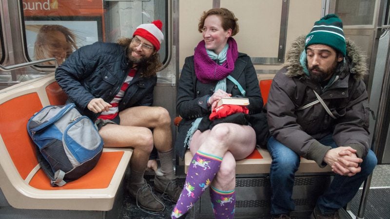 Friends who identified themselves as Waldo, (left) and Koryn (center) participate in the  No Pants Subway Ride on the Broad Street Line, January 8, 2017. (Jonathan Wilson for Newsworks)