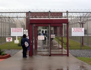 An ICE employee waiting to enter the all-male Stewart Detention Center in Lumpkin, Ga. (Kate Brumback/AP)