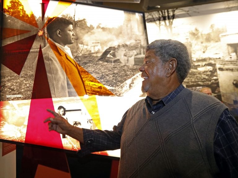 Harold Dahmer, whose father Vernon Dahmer was killed in 1966 by the Ku Klux Klan, smiles when he sees a photograph of his younger self on display at the Mississippi Civil Rights Museum. (Rogelio V. Solis/AP)