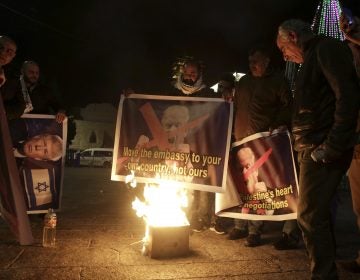 Palestinians burn a poster of President Trump during a protest in Bethlehem, West Bank, on Wednesday.