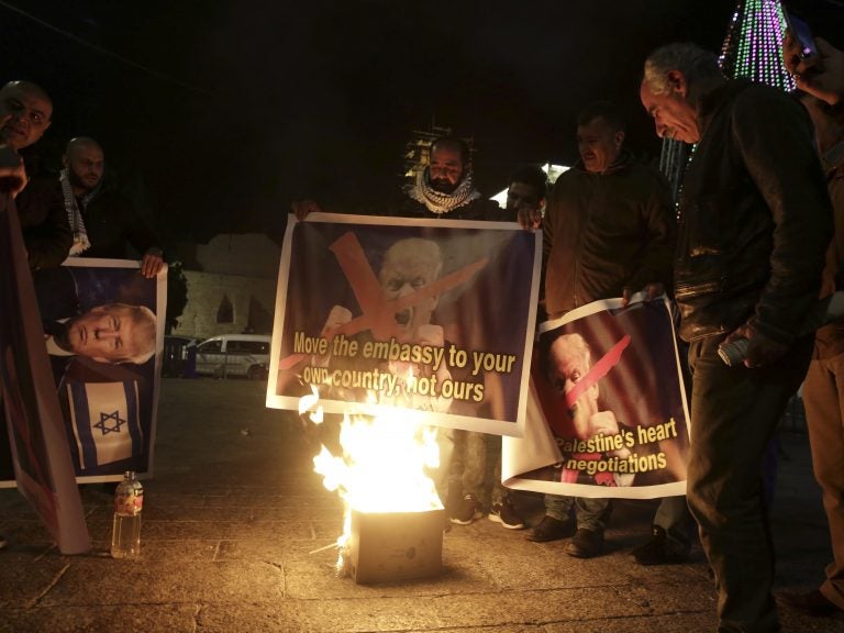 Palestinians burn a poster of President Trump during a protest in Bethlehem, West Bank, on Wednesday.